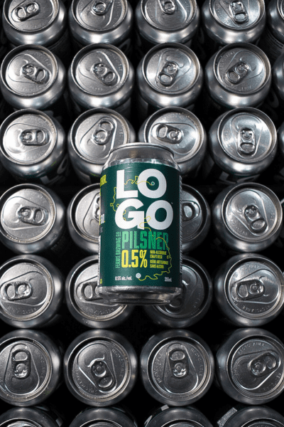 A can of LOGO Pilsner on top of a flat of 355 mL cans